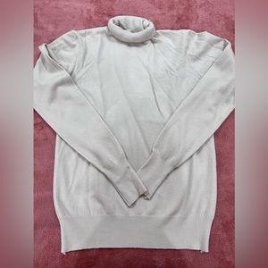 Small cream colored turtleneck sweater